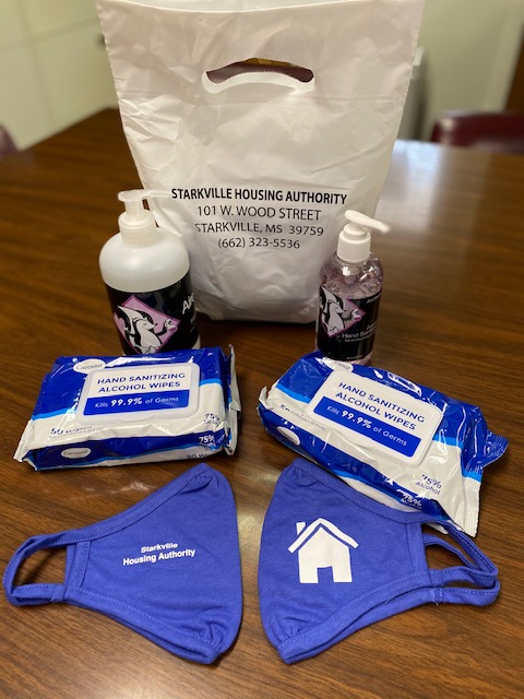 Masks, wipes and sanitizer displayed on a table