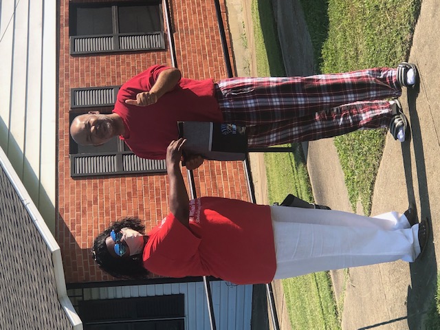 Man and woman posing for a photo with gift