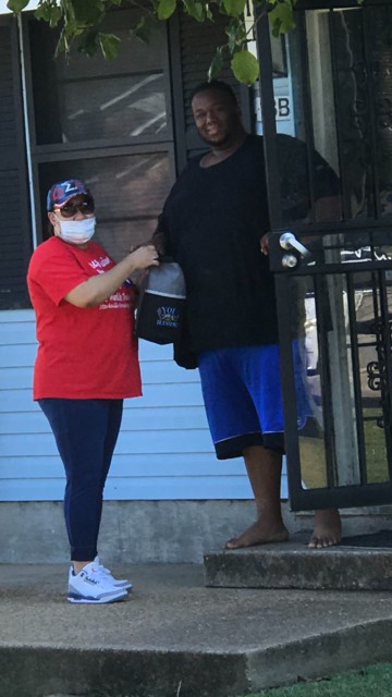 Man and woman posing for a photo with gift