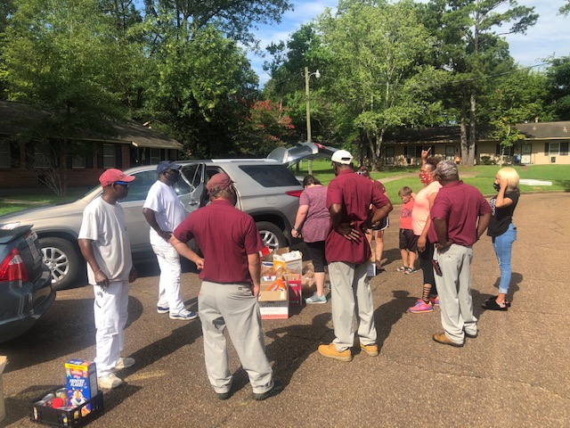 Group of people unloading supplies