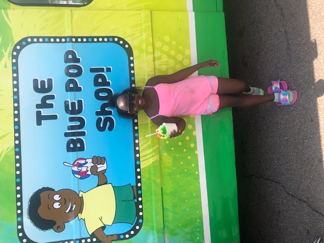 Girl posing in from of an ice cream truck