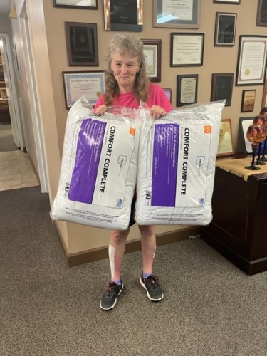 Woman with new pillows won from the raffle