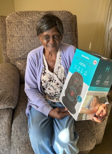 Woman with a heated chair pad won from the raffle