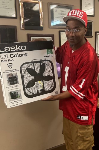 Man with new box fan won from the raffle
