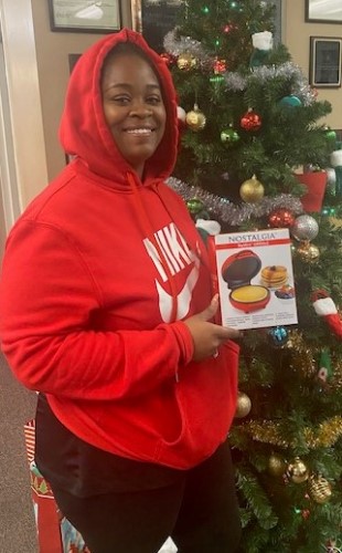 Woman with a new mini waffle maker won from the raffle